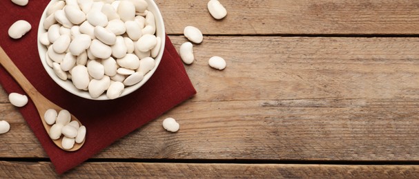 Image of White beans and space for text on wooden table, flat lay. Banner design