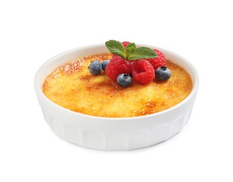 Photo of Delicious creme brulee with fresh berries isolated on white