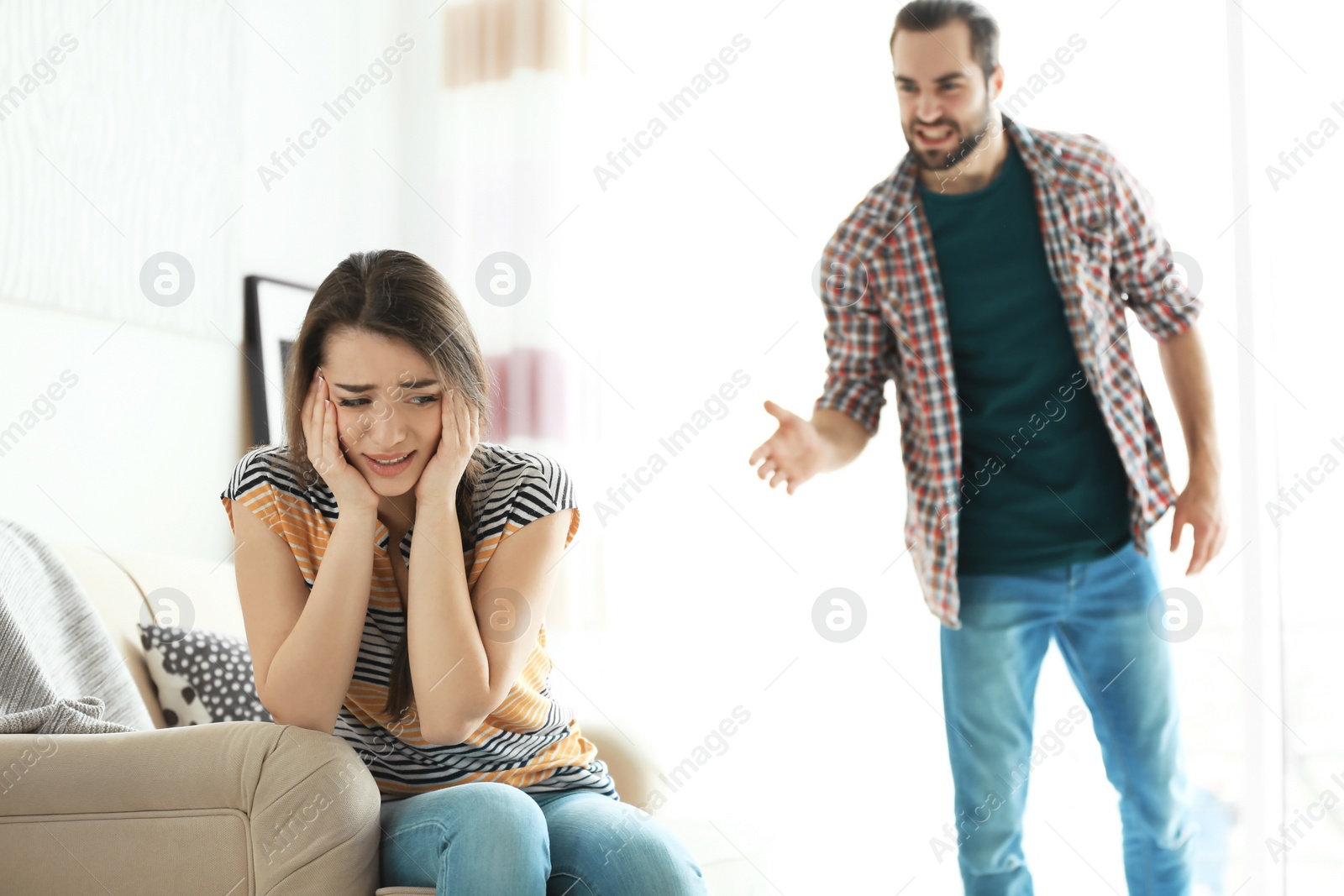 Photo of Young couple having argument in living room