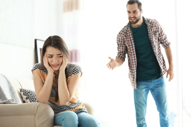 Photo of Young couple having argument in living room