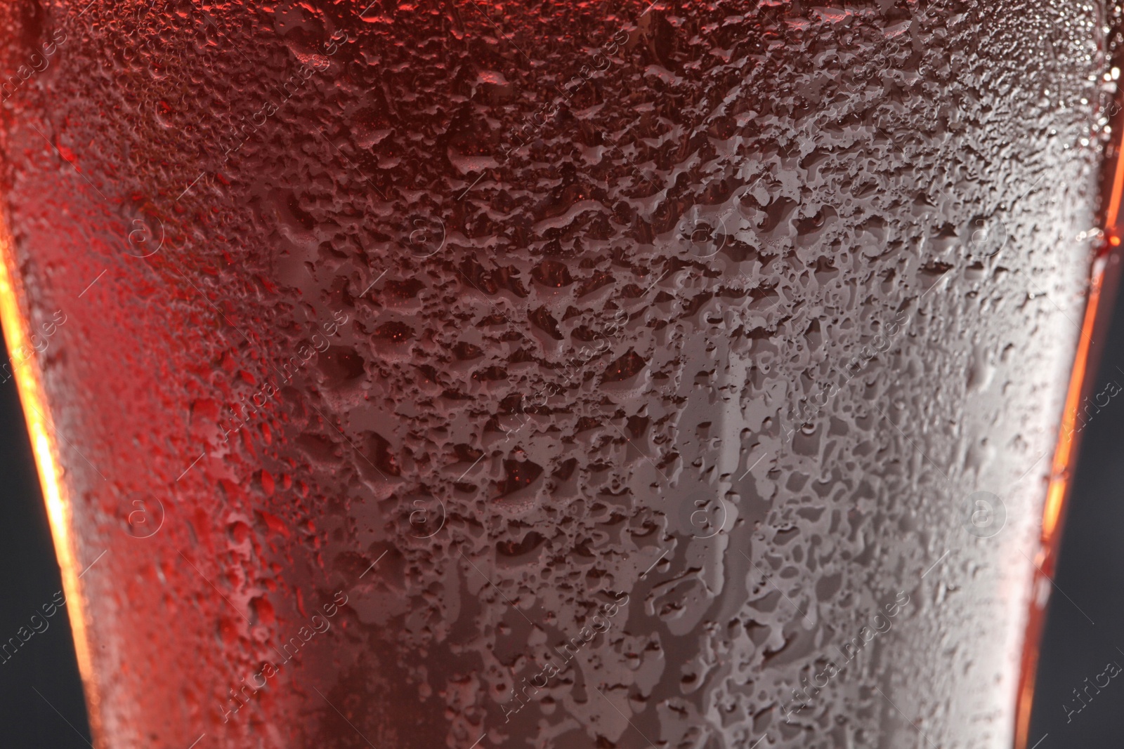 Photo of Glass of tasty red beer, closeup. Alcoholic drink