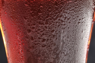 Photo of Glass of tasty red beer, closeup. Alcoholic drink