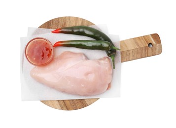Marinade, basting brush, raw chicken fillets and chili peppers isolated on white, top view