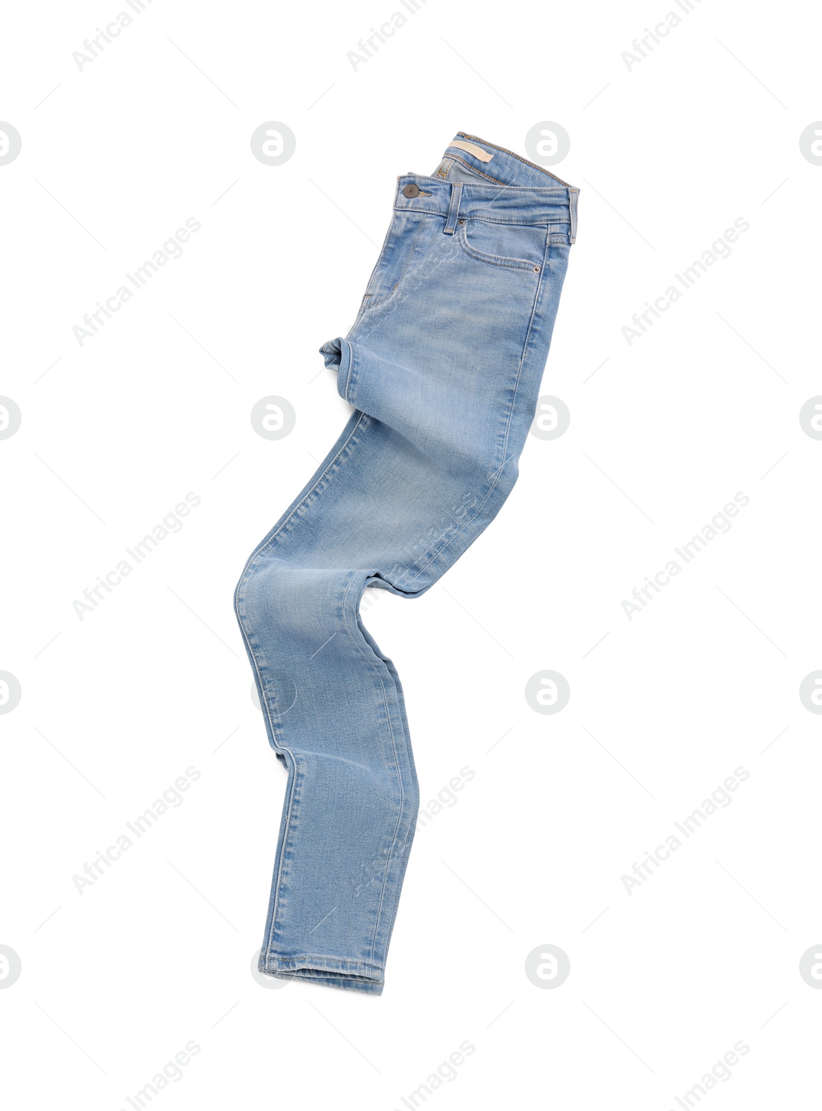 Photo of Stylish light blue jeans isolated on white, top view