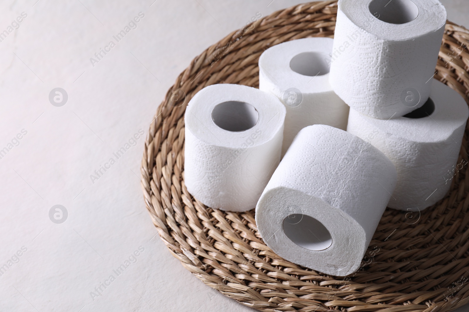 Photo of Toilet paper rolls on white table, space for text