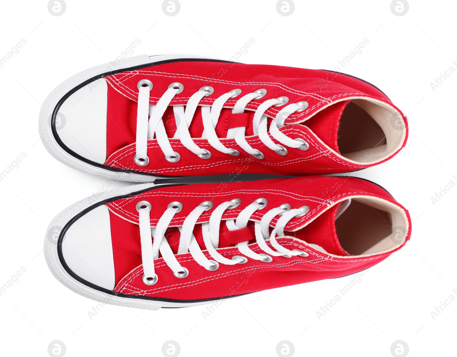 Photo of Pair of new red stylish plimsolls on white background, top view