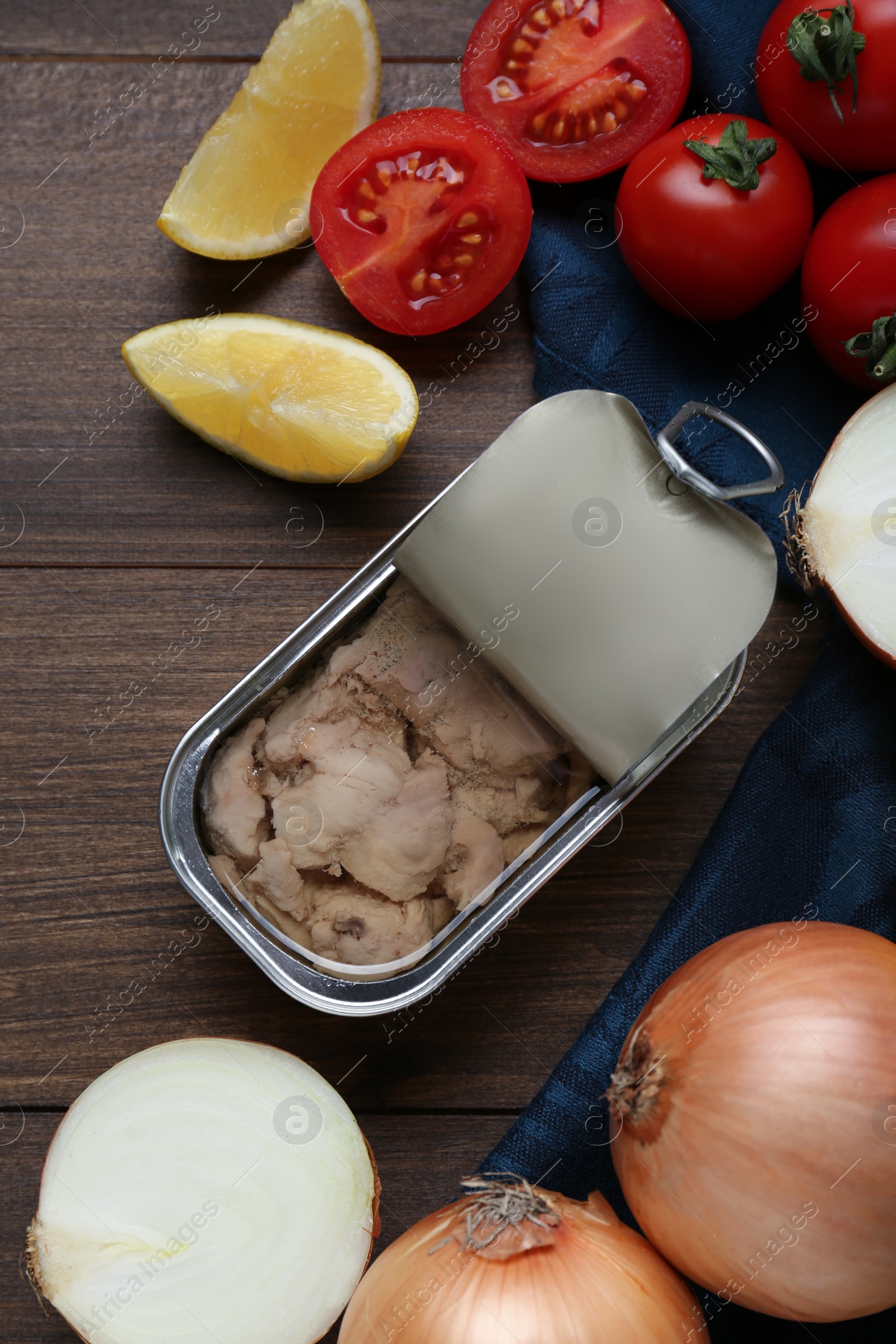 Photo of Flat lay composition with tin can of tasty cod liver and different products on wooden table