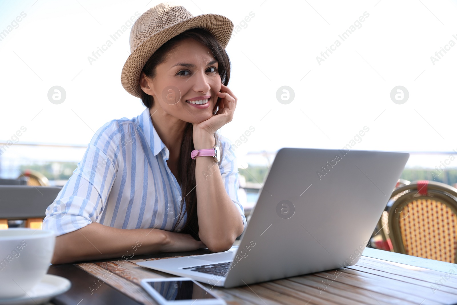 Photo of Beautiful woman with laptop at outdoor cafe