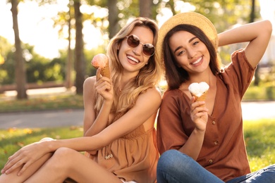 Young women with ice cream spending time together outdoors