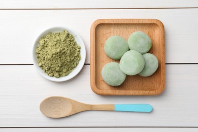 Delicious matcha mochi on white wooden table, flat lay