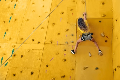 Photo of OCHAKIV, UKRAINE - JULY 09, 2020: Girl on climbing wall in summer camp "Sportium", back view