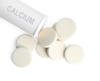 Image of Calcium supplement. Bottle and tablets on white background, top view