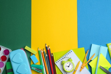 Photo of Different bright school stationery on color background, flat lay. Space for text