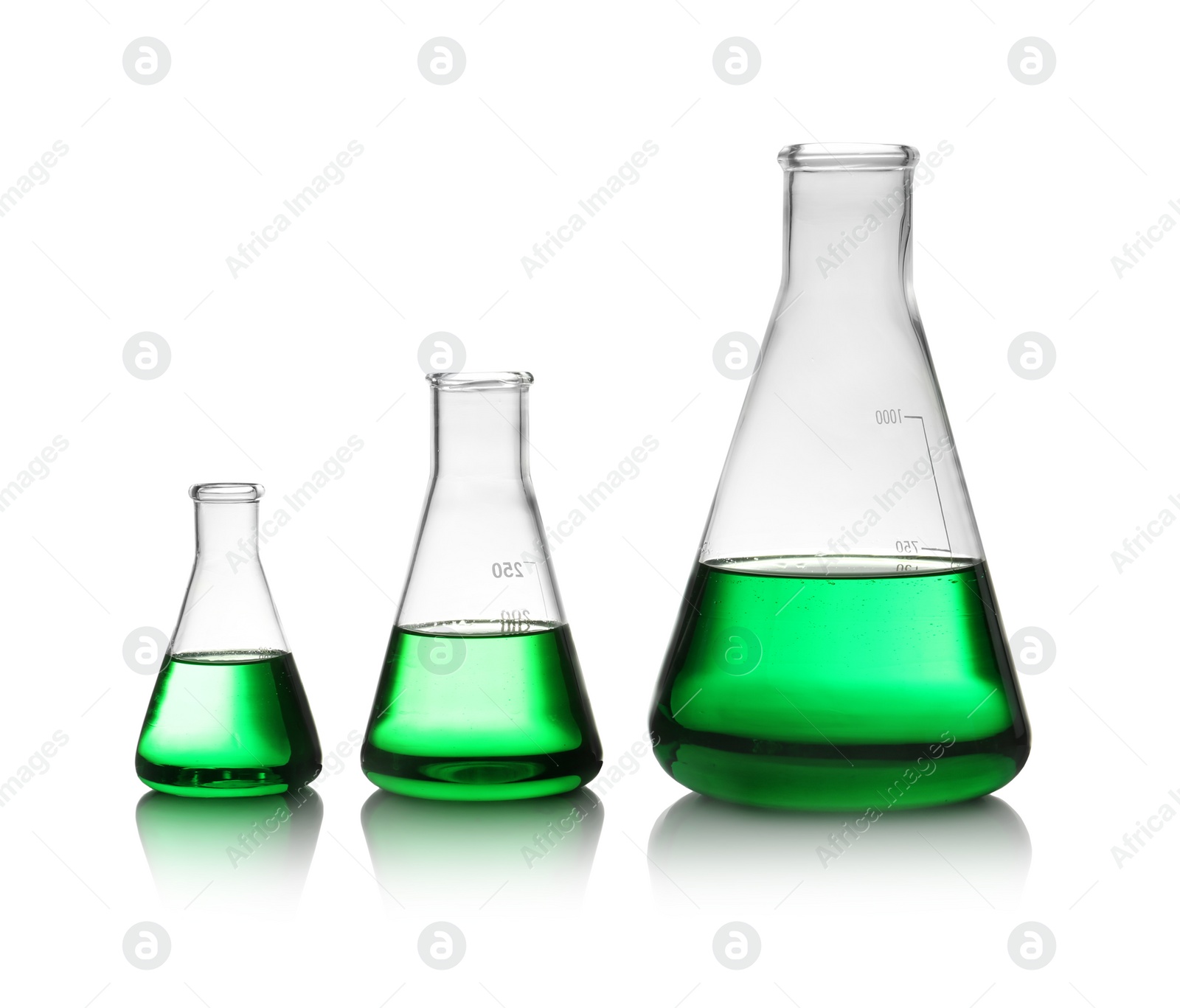 Photo of Conical flasks with green liquid on white background