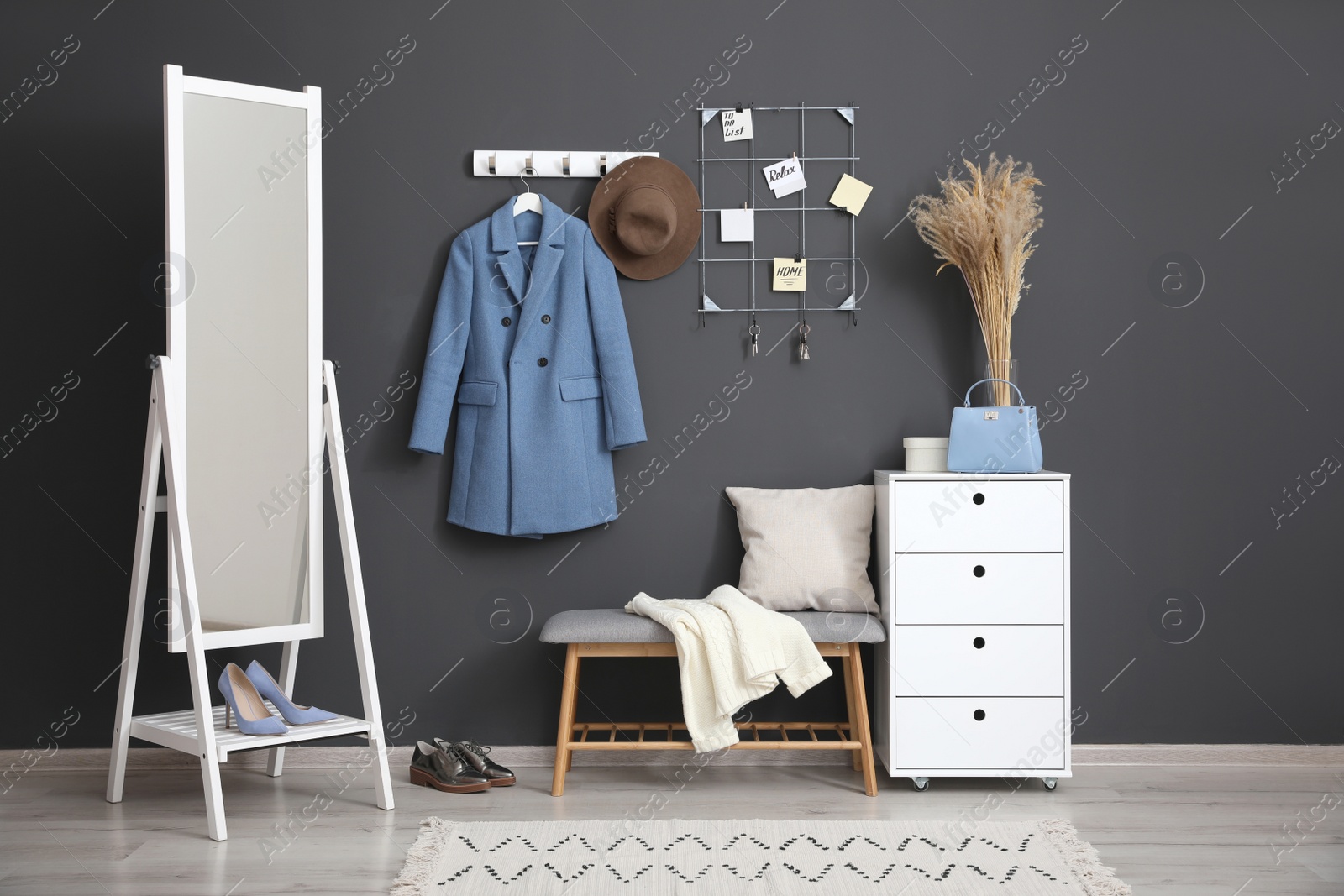 Photo of Hallway interior with stylish furniture, clothes and accessories
