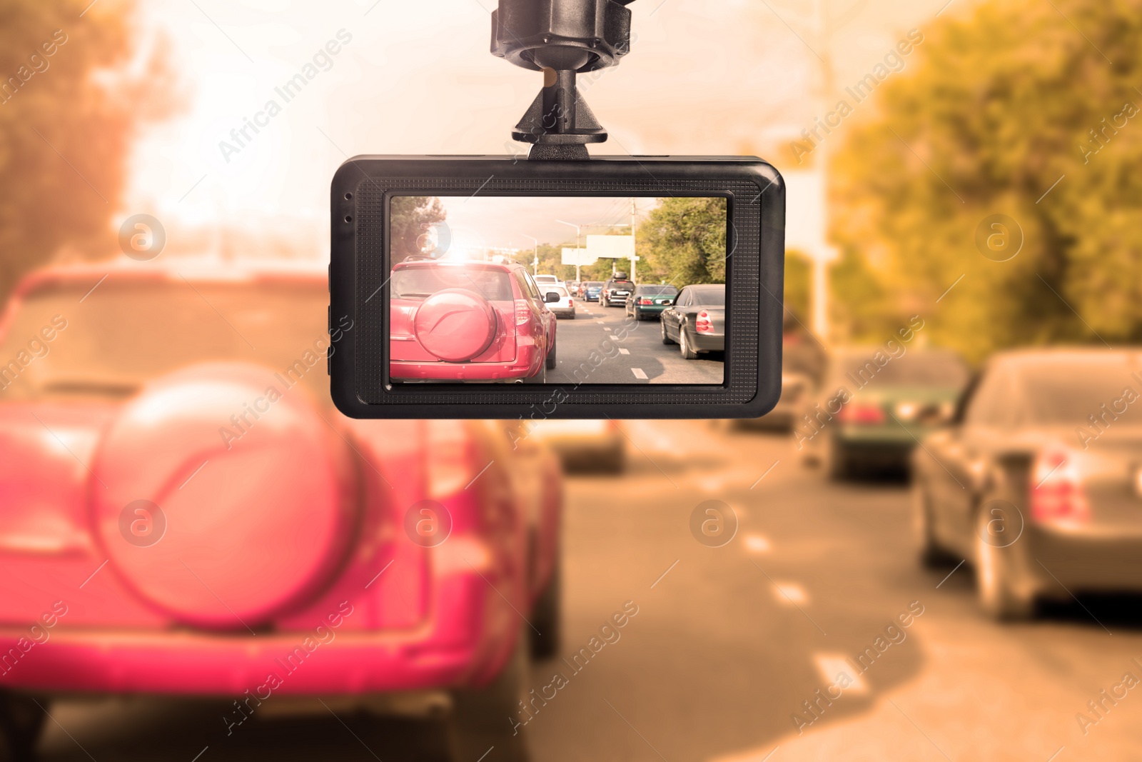 Image of Modern dashboard camera mounted in car, view of road during driving