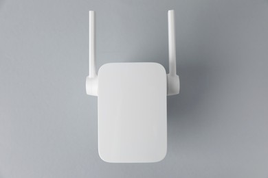 New modern Wi-Fi repeater on light gray background