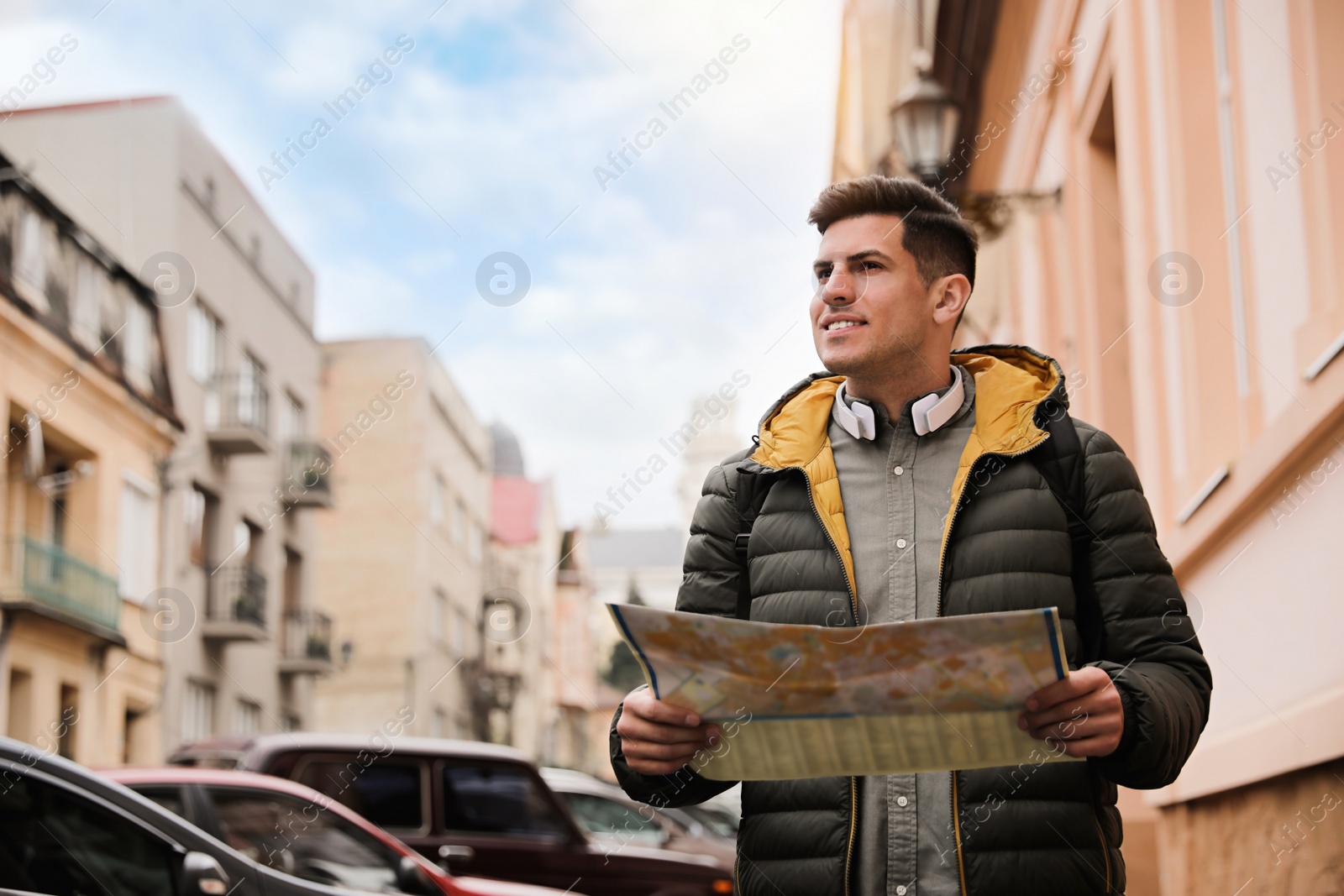 Photo of Tourist with map walking on city street