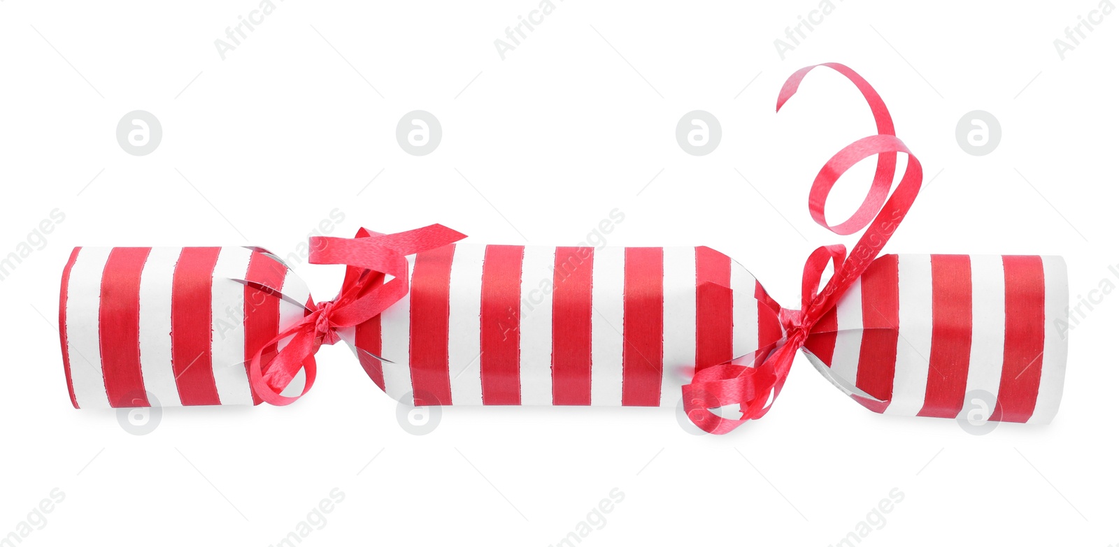 Photo of Bright striped Christmas cracker isolated on white, top view