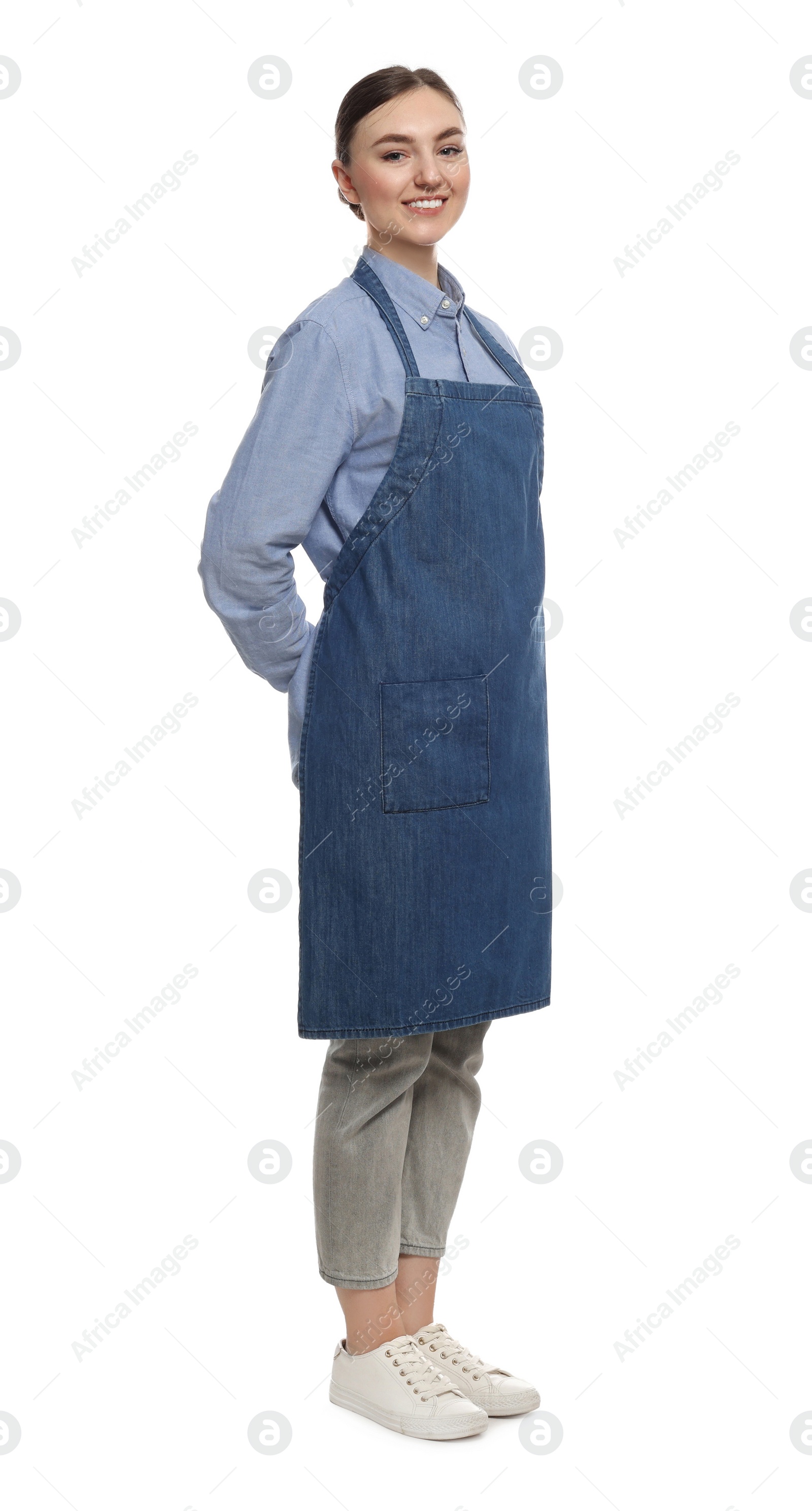 Photo of Beautiful young woman in clean denim apron on white background