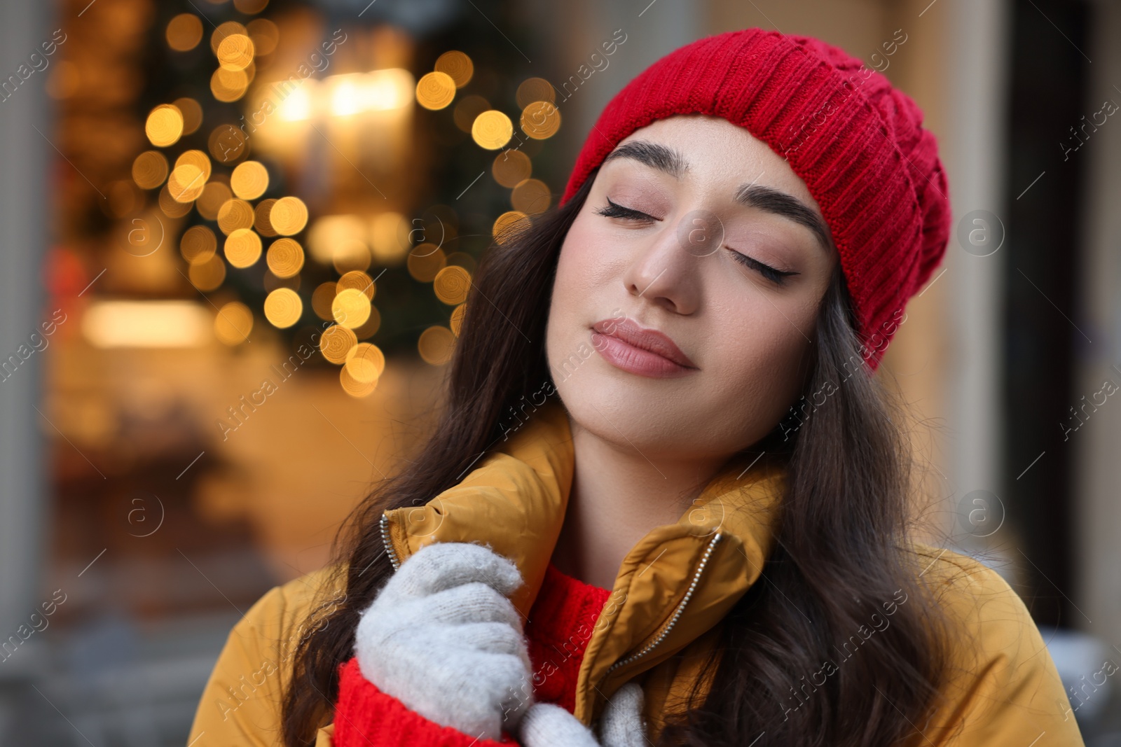 Photo of Portrait of beautiful woman on city street in winter