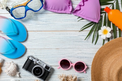 Photo of Flat lay composition with beach objects on wooden background