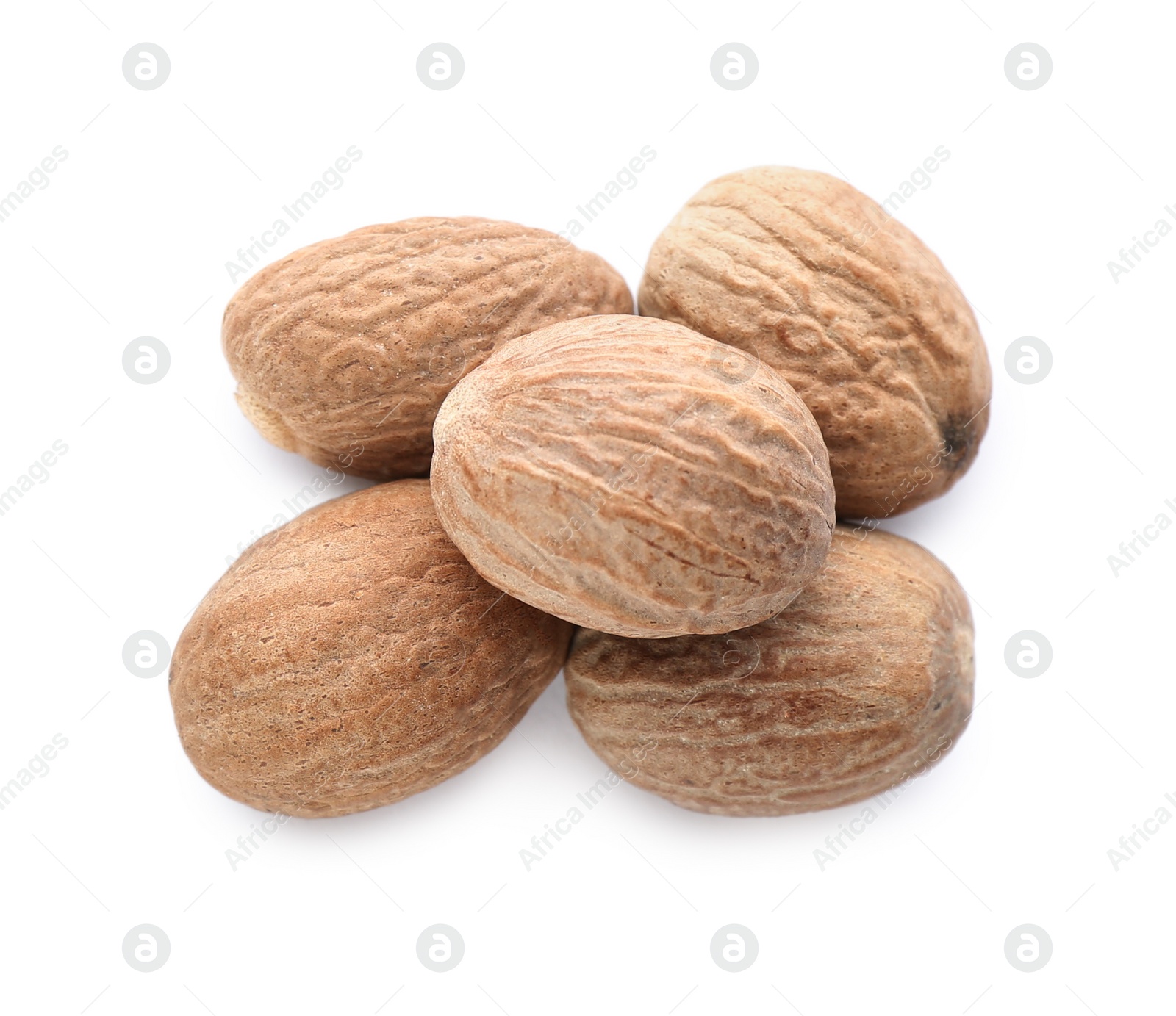 Photo of Heap of nutmeg seeds isolated on white, top view