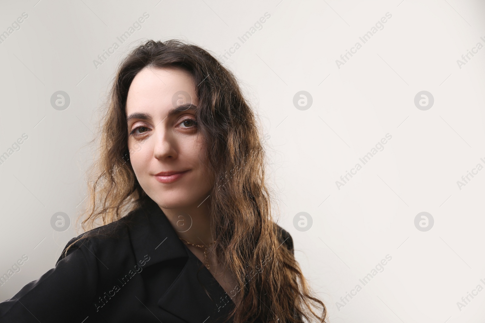 Photo of Portrait of beautiful woman on beige background. Space for text