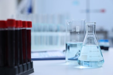 Photo of Laboratory glassware with samples on table indoors