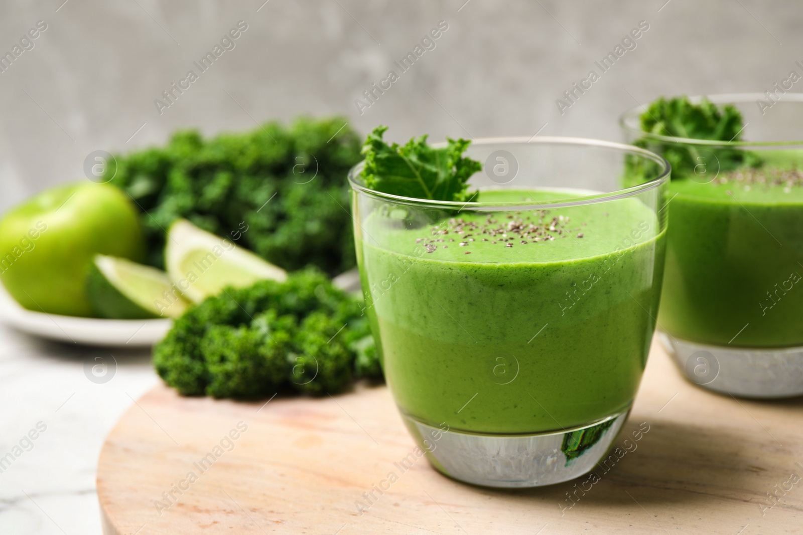 Photo of Tasty kale smoothie with chia seeds on table, closeup