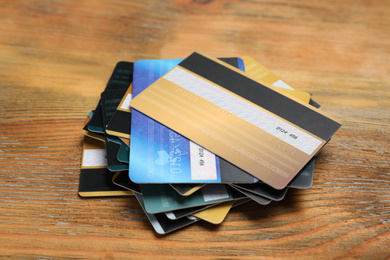 Many different credit cards on wooden table