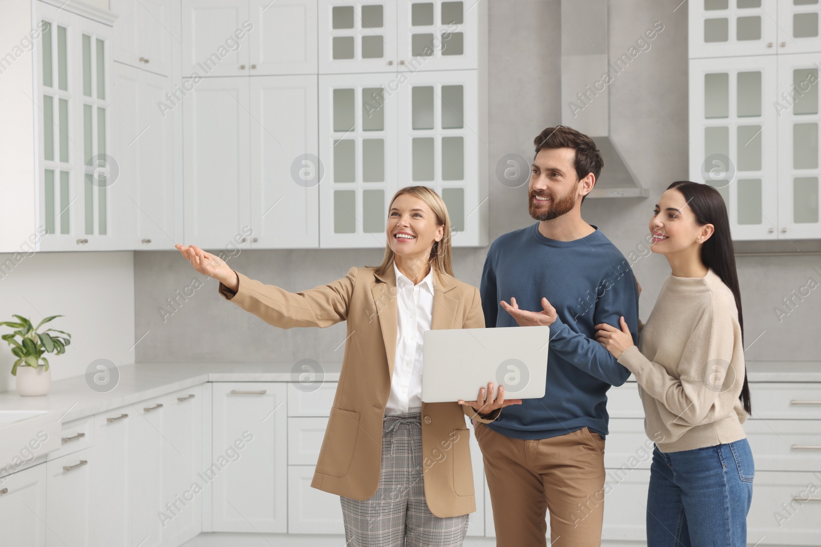 Photo of Real estate agent showing new apartment to couple