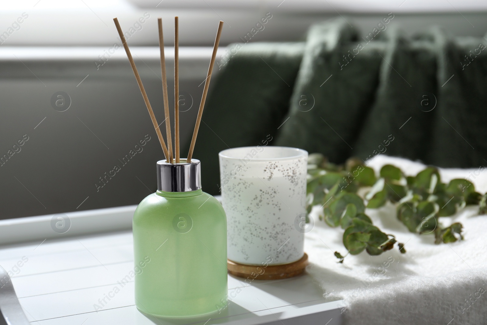 Photo of Reed air freshener on white tray indoors