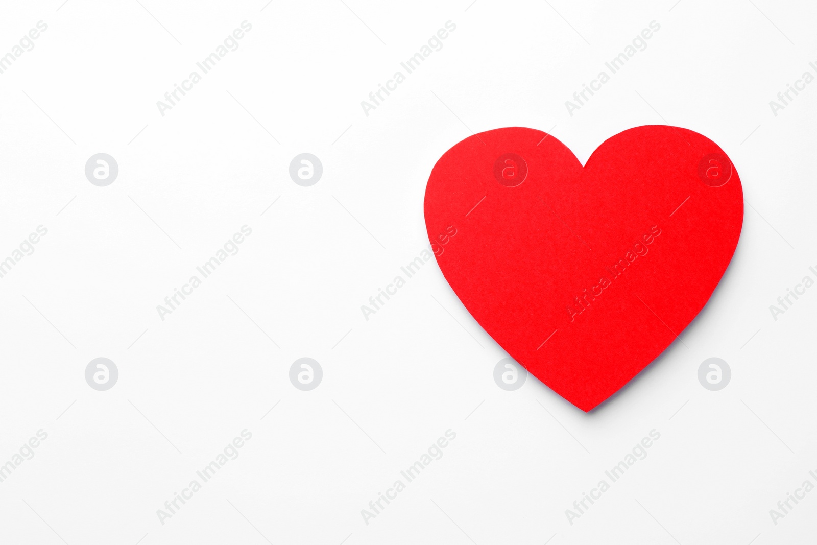 Photo of One paper heart on white background, top view. Space for text