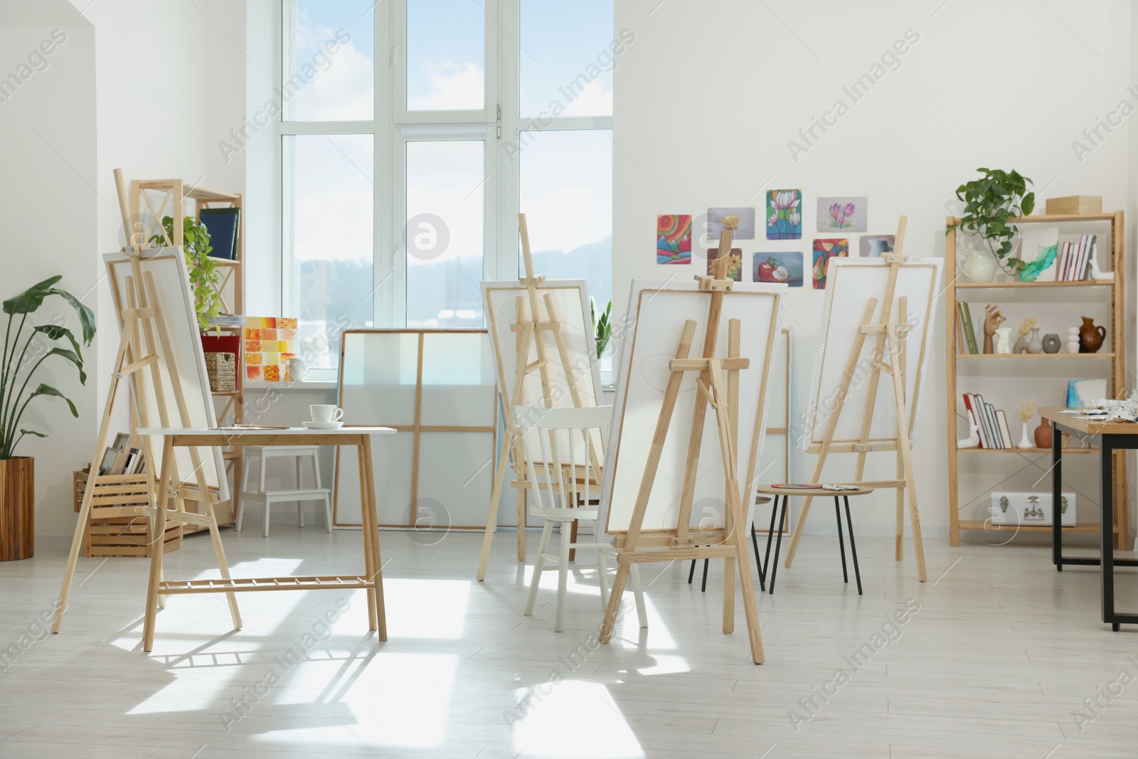 Photo of Stylish artist's studio interior with easels and canvases. Creative hobby