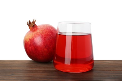 Photo of Refreshing pomegranate juice in glass and fruit on wooden table against white background