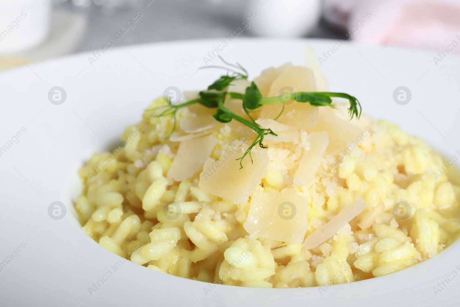 Photo of Delicious risotto with cheese in plate, closeup