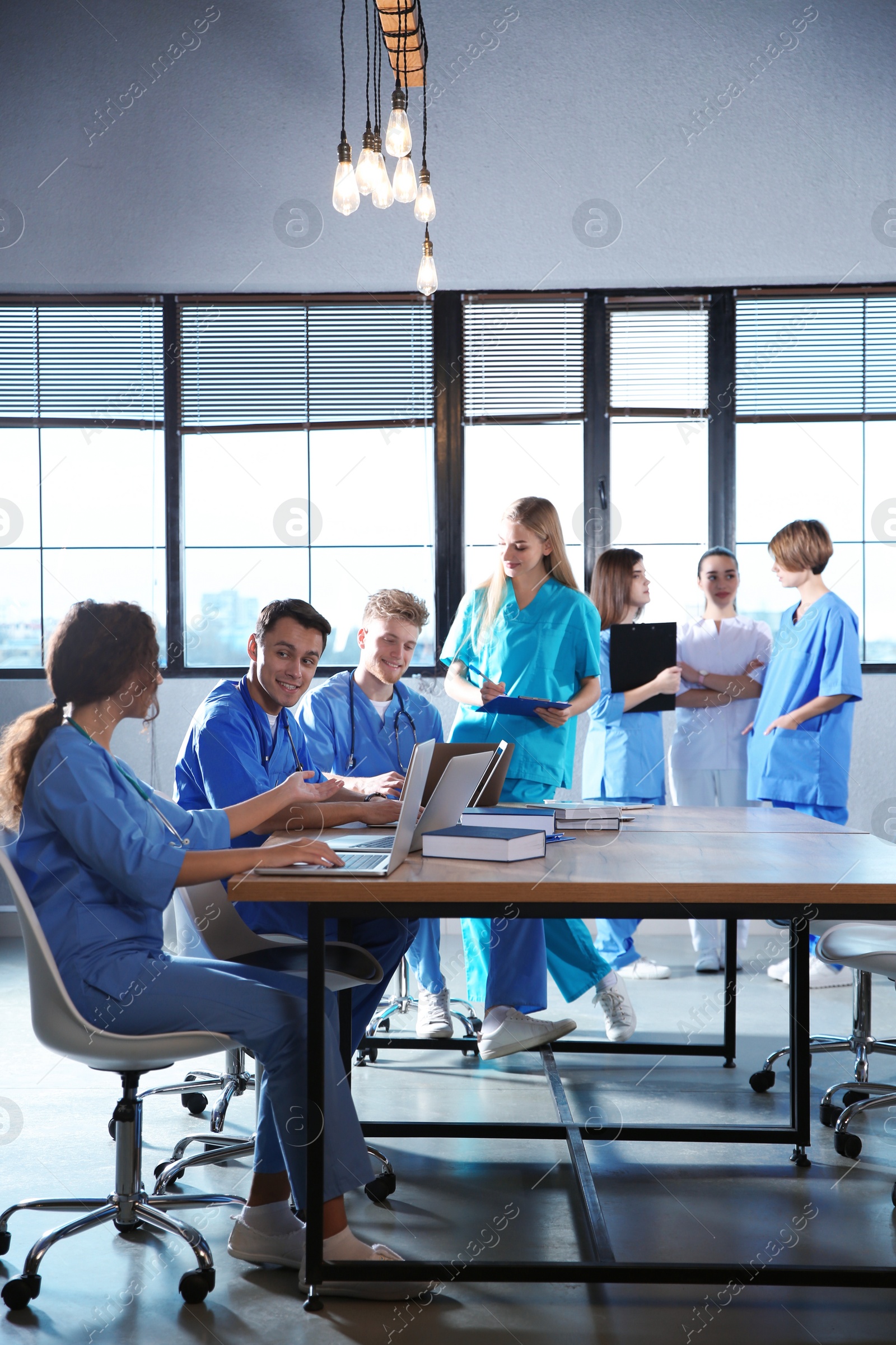 Photo of Group of smart medical students with gadgets in college