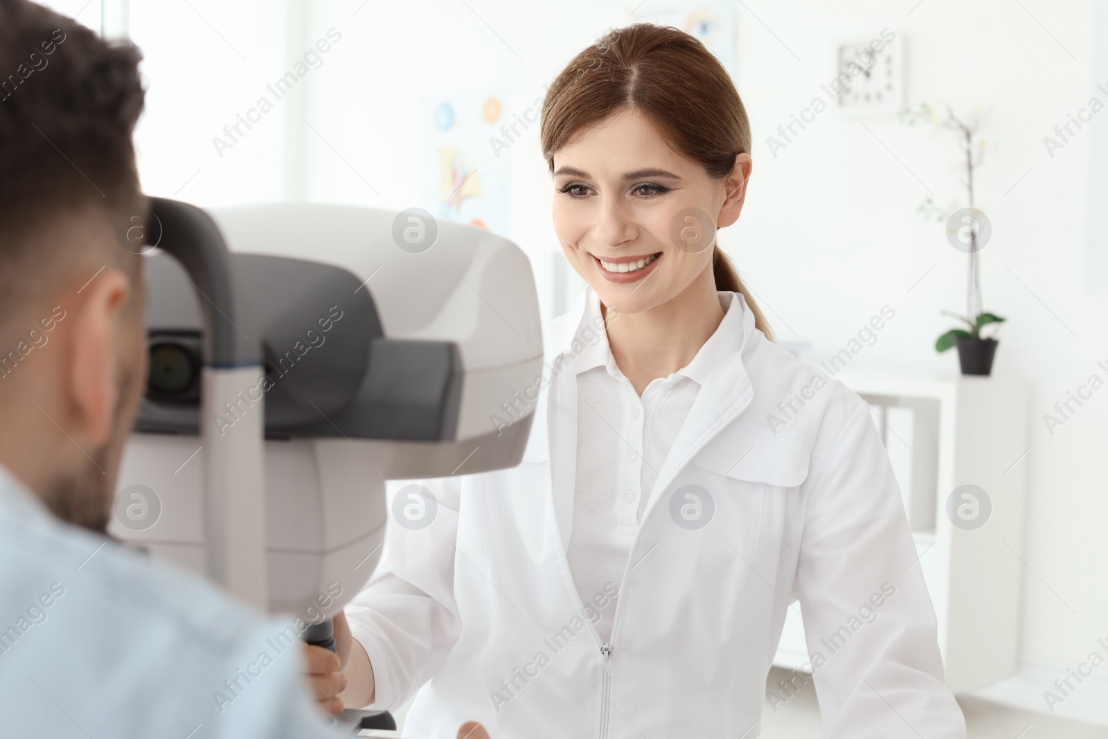 Photo of Ophthalmologist examining patient in clinic