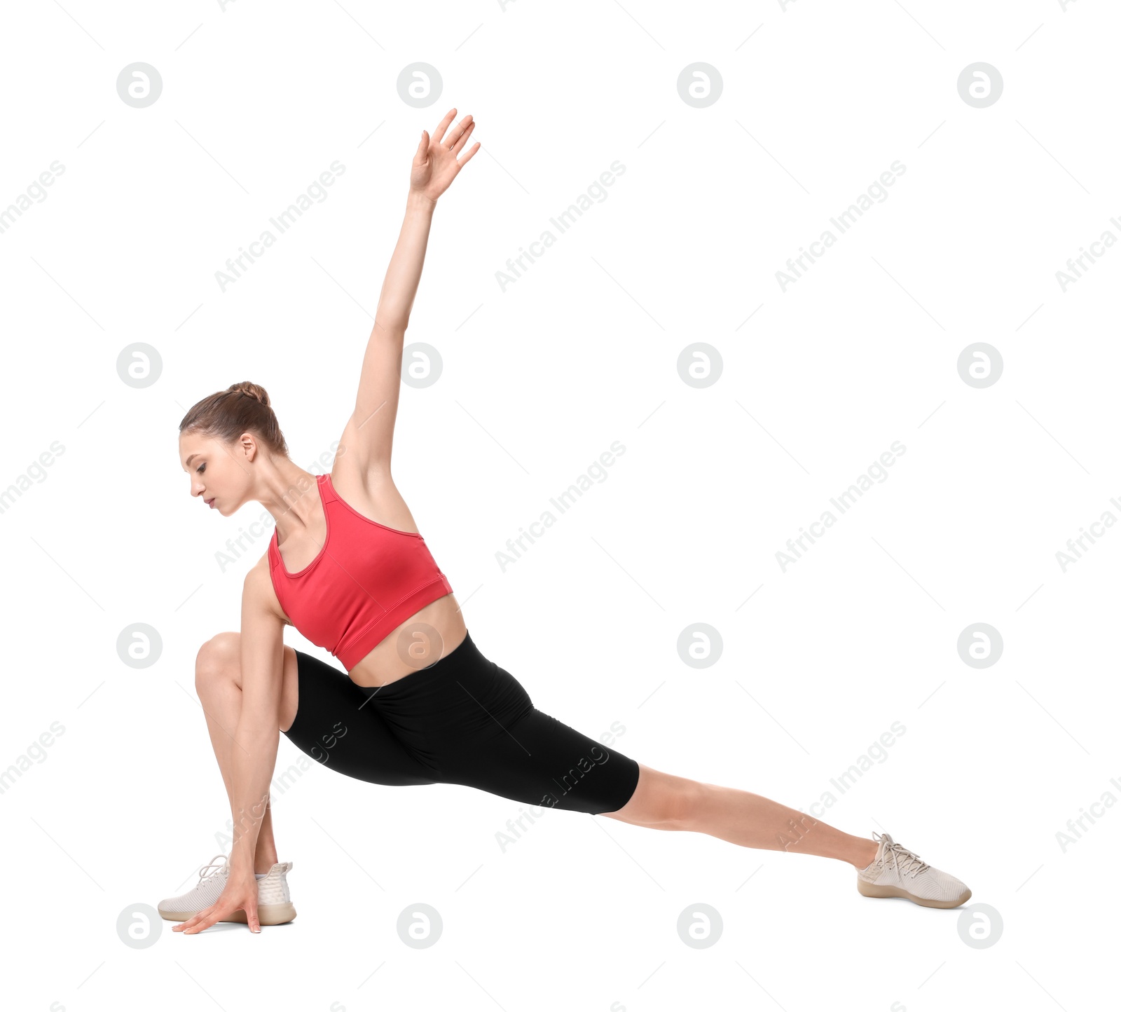 Photo of Yoga workout. Young woman stretching on white background