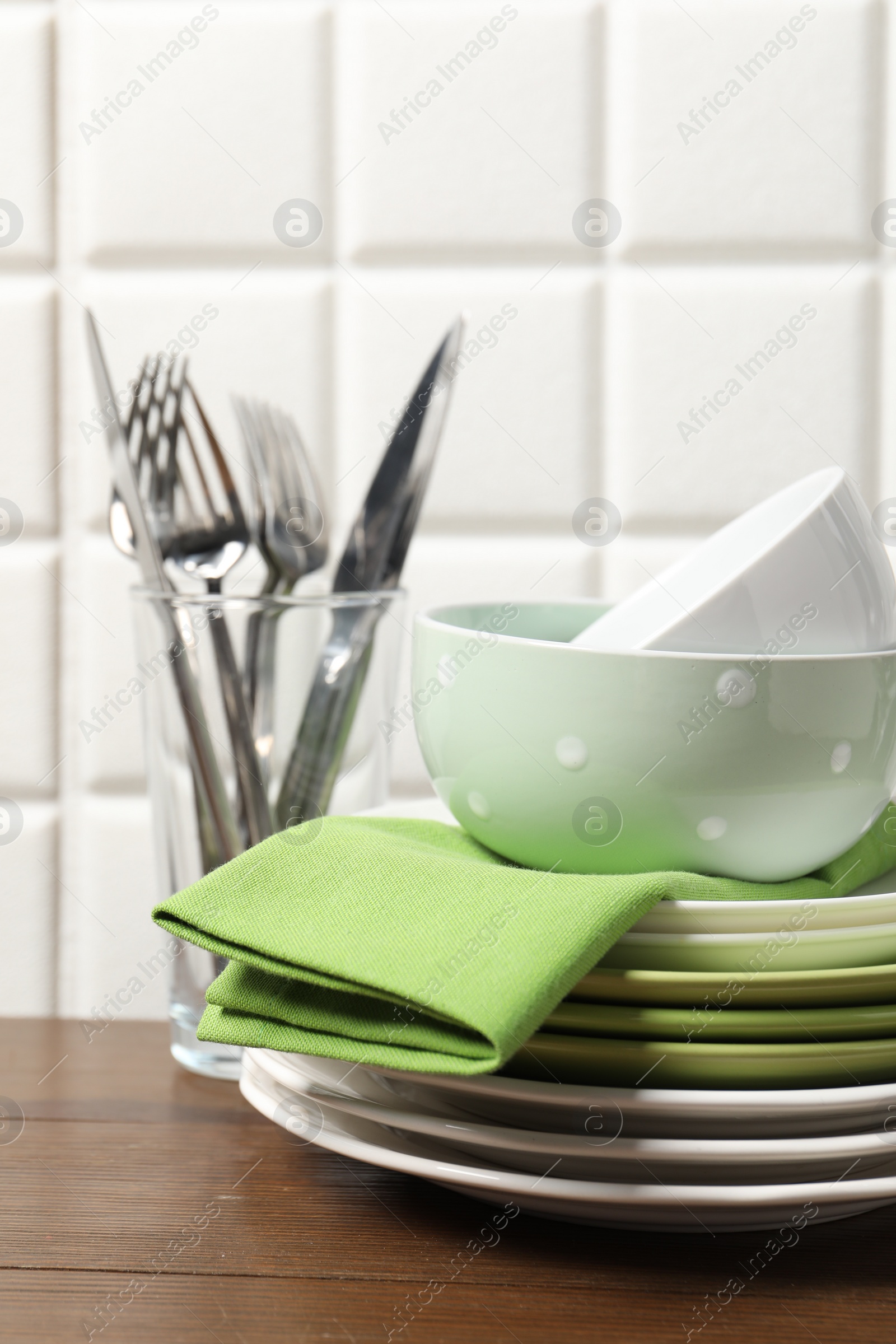 Photo of Beautiful ceramic dishware and cutlery on wooden table