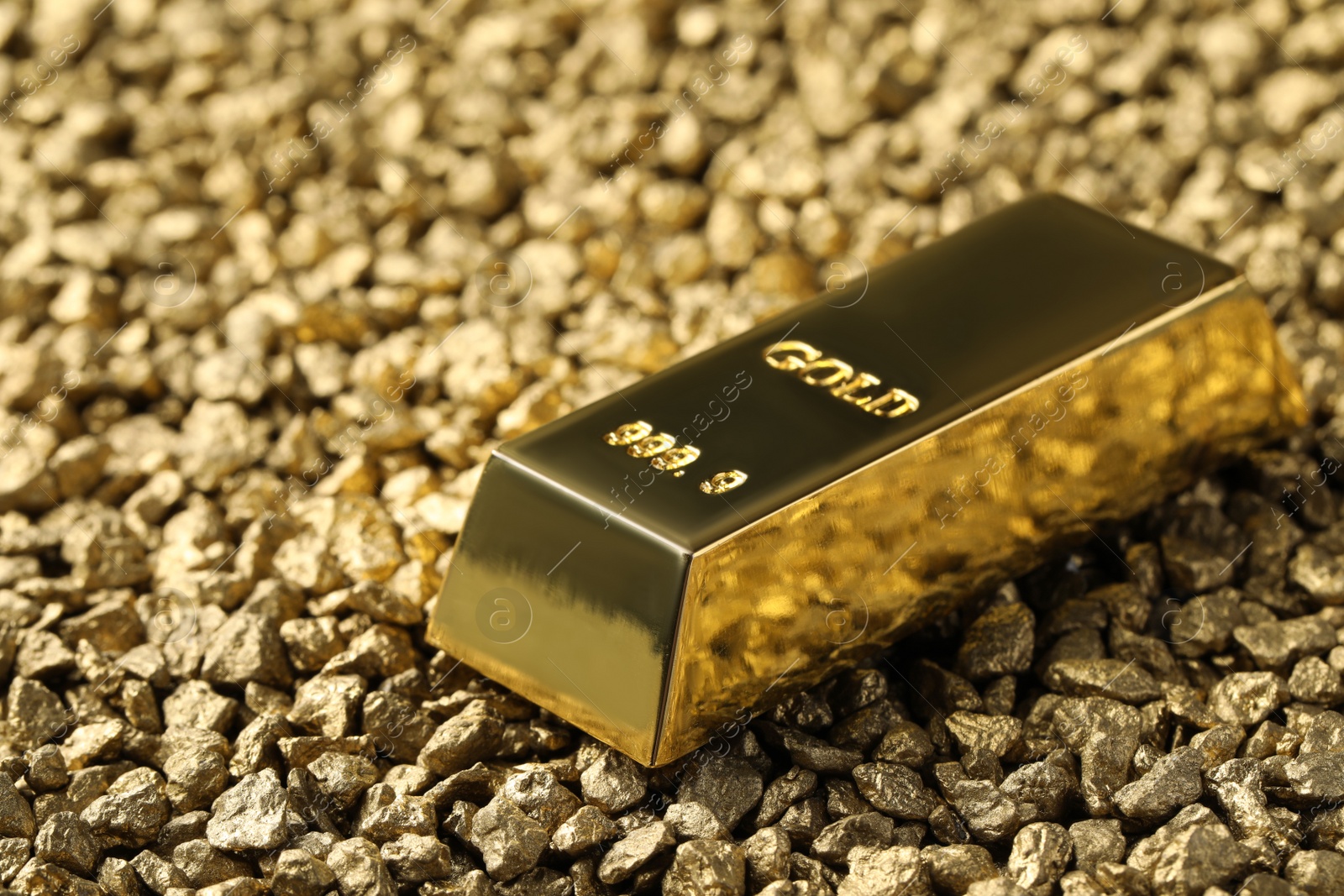 Photo of One gold ingot on nuggets, closeup view. Space for text
