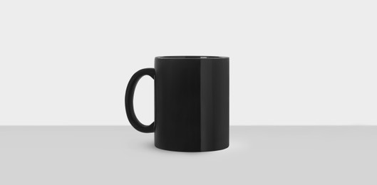 Image of Black ceramic mug on white background, banner design. Mockup for design