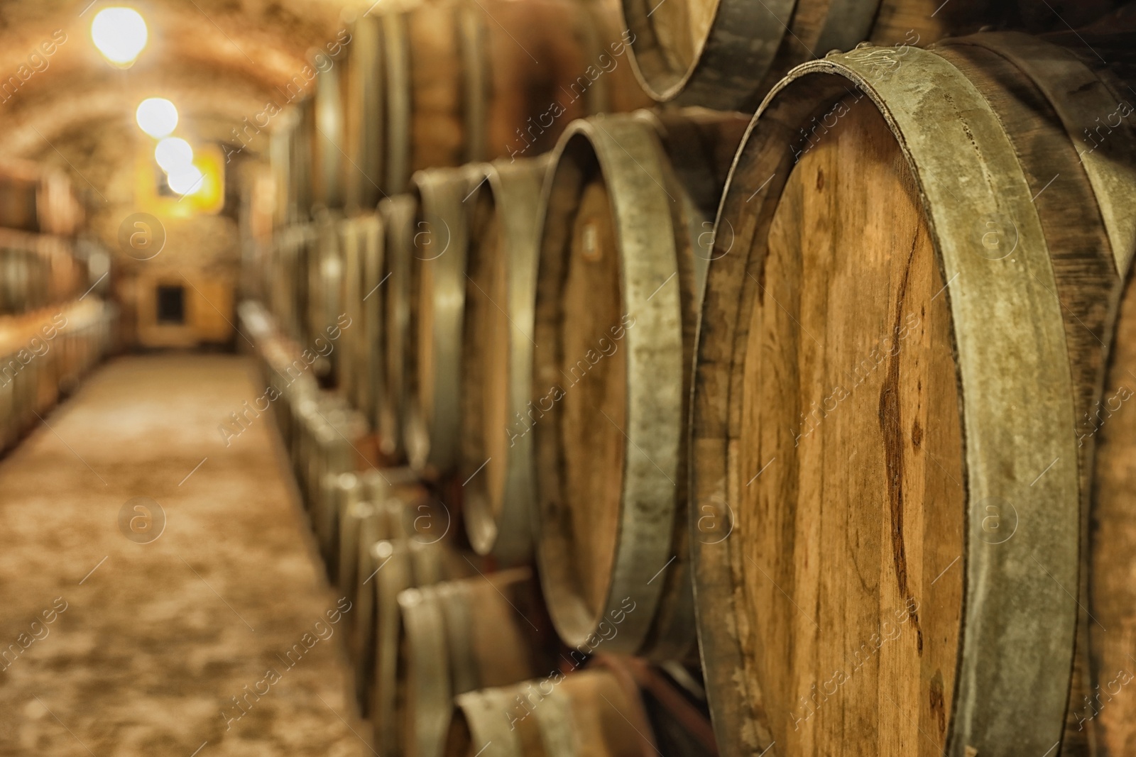 Photo of Large wooden barrels in wine cellar, closeup