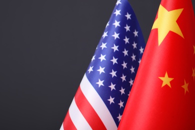 Closeup view of USA and China flags on dark background, space for text. International relations