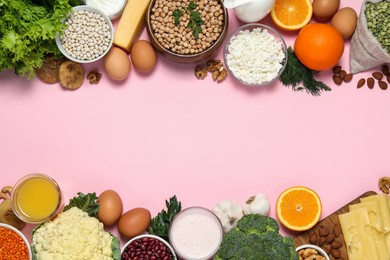 Photo of Food high in calcium. Flat lay composition with different products on pink background ,space for text