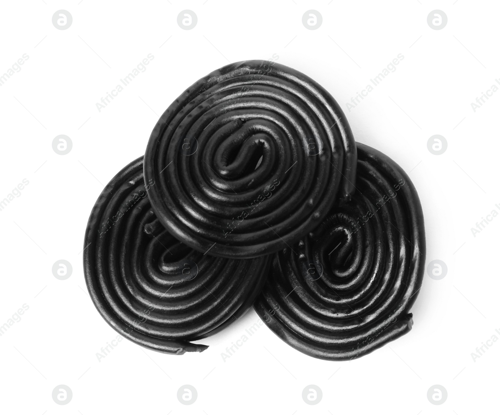 Photo of Tasty black liquorice candies on white background, top view