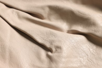 Beige natural leather as background, closeup view