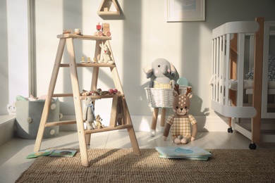 Beautiful baby room interior with stylish wooden ladder