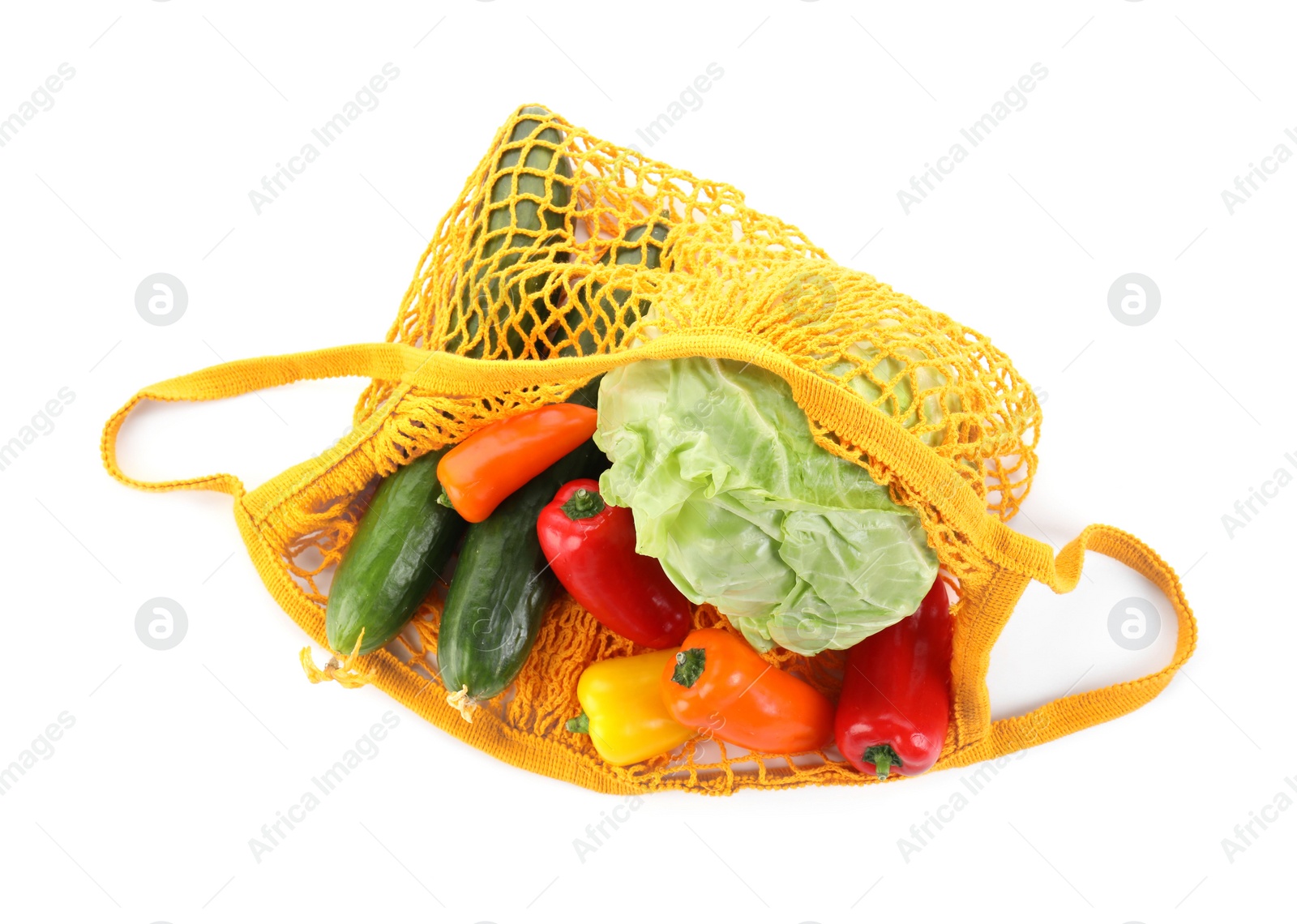 Photo of String bag with different vegetables isolated on white, top view